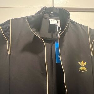ADIDAS, WOMANS ONE PIECE JUMPER WITH GOLD ZIPPER, HIDDEN PEEKABOO SHOULDER ZIP.